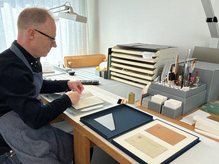 A conservator is working on the gift.