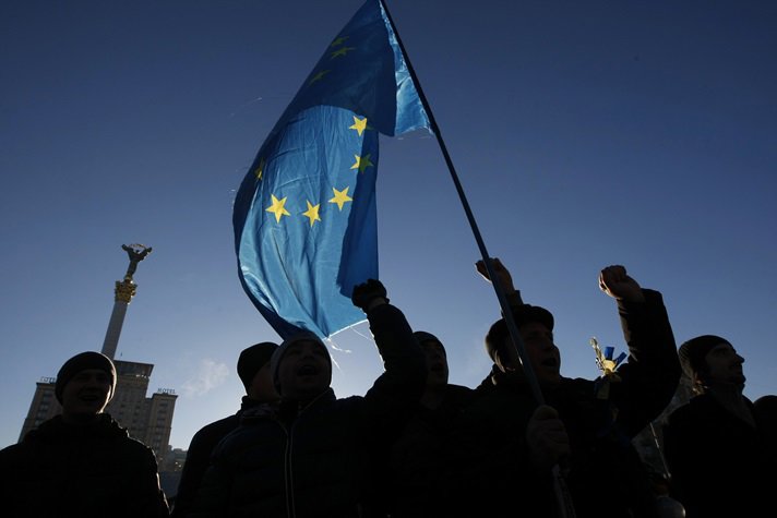 Protesters wave flags on Independence Square in Kiev.