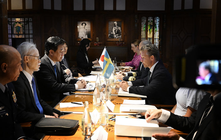 The ministers at a meeting table.